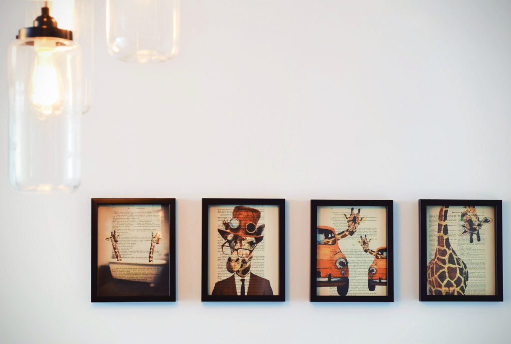 Four Quirky Giraffe Paintings on Wall