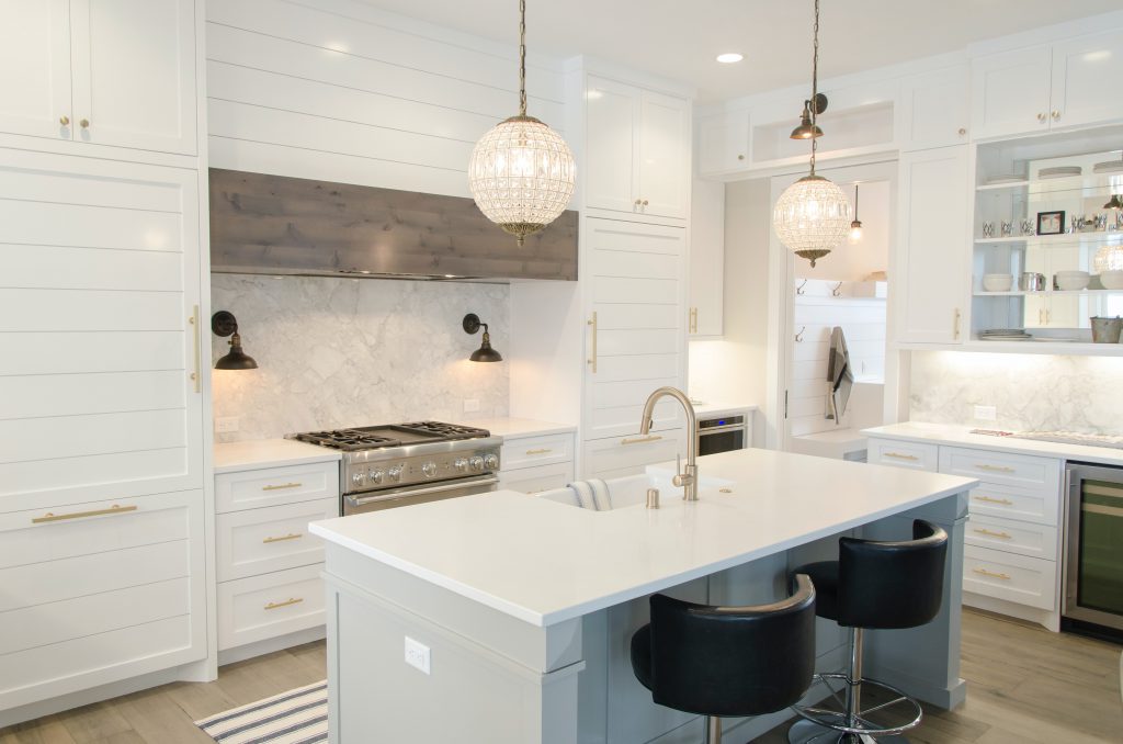 beautiful bright white kitchen with pendant lights over island