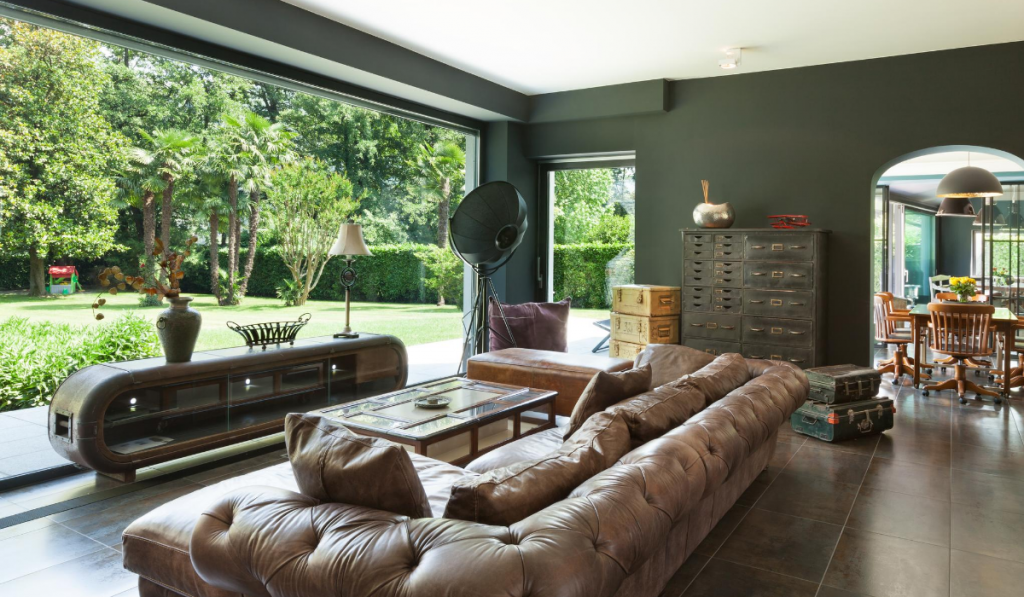 beautiful living room with modern industrial decor leather couch floor to ceiling window