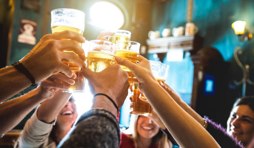 group at a brewery raising their glasses in a toast