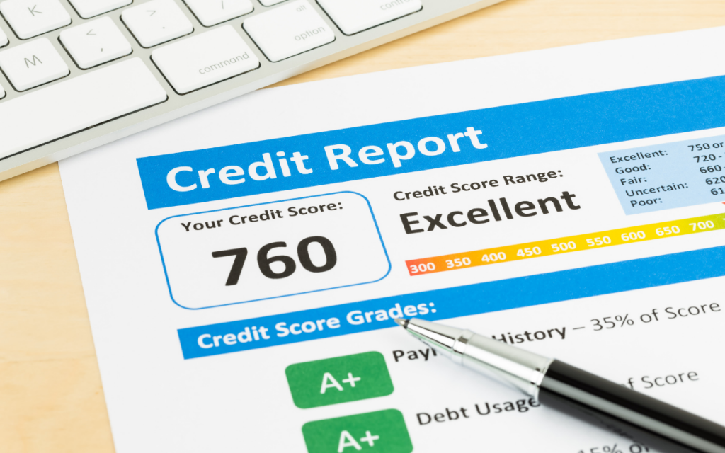 credit report next to laptop with pen excellent credit