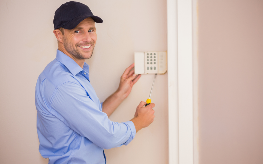 handyman fixing thermostat