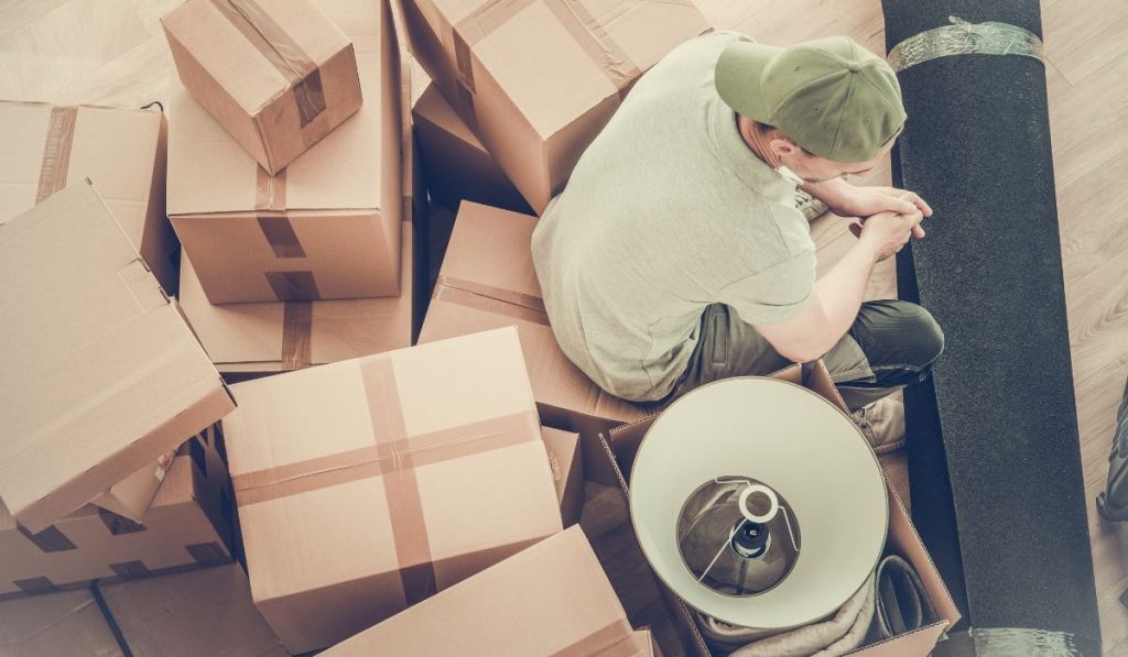 man sitting on top of the boxes