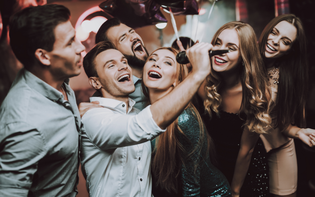 three couples singing having fun karaoke group date