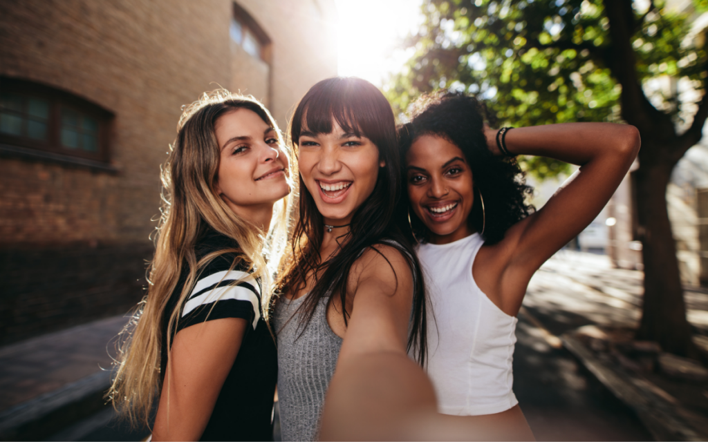 three young women friends taking selfie