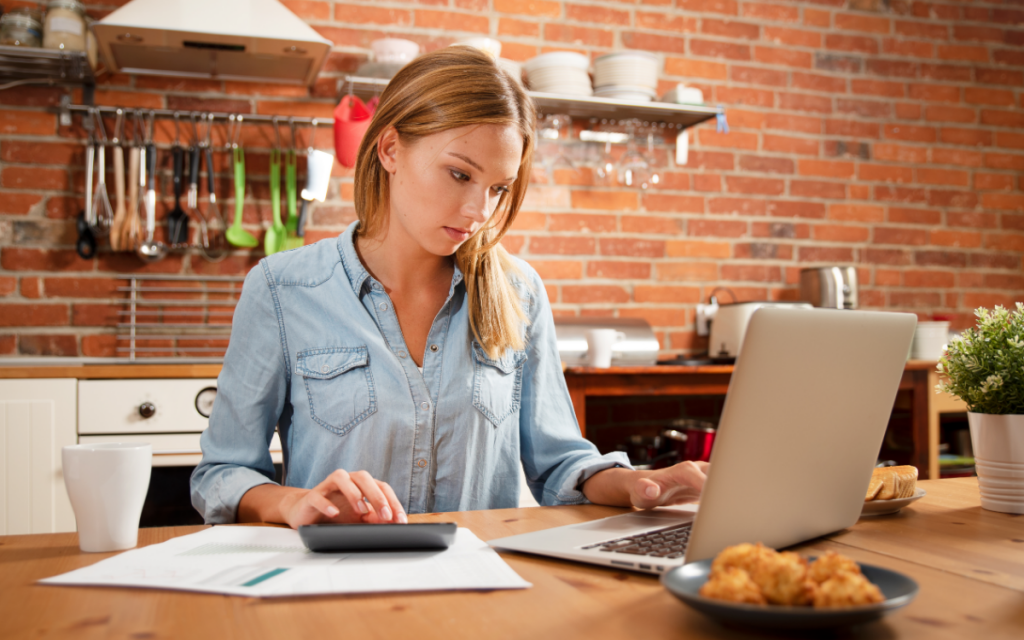 young woman planning budget on laptop