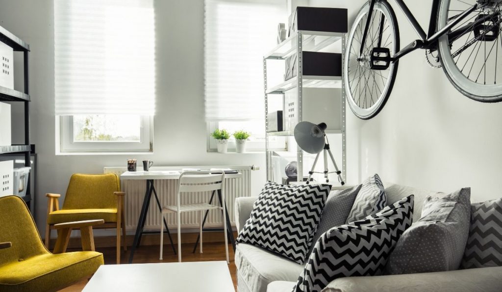 micro apartment with a bike hanging on the wall; black and white colors