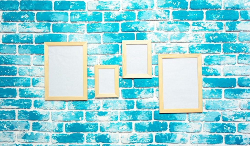 wall painted in aqua and white with picture frames