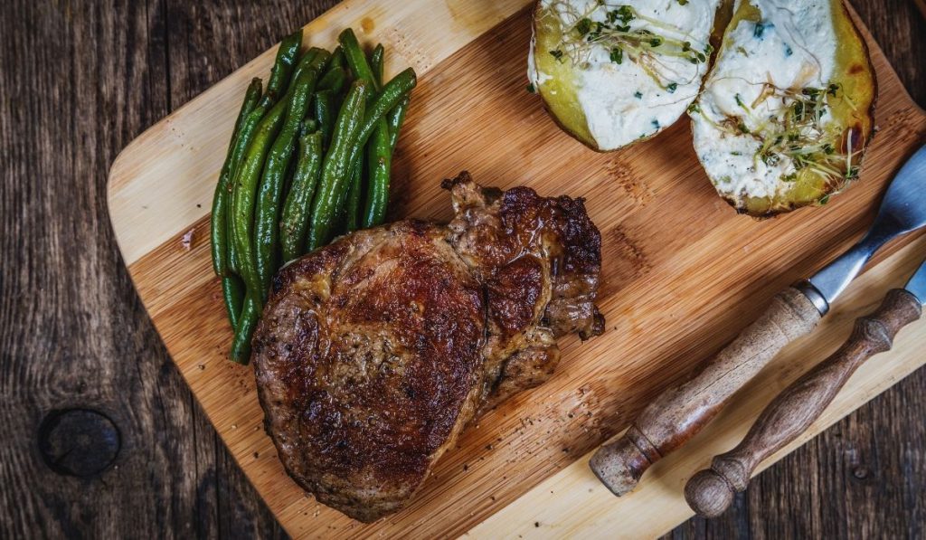 steak, some greens and baked potato