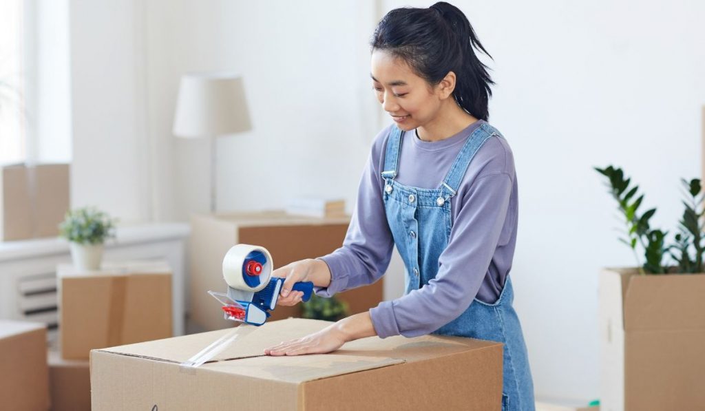 female college student packing her stuff, moving out from her parents house