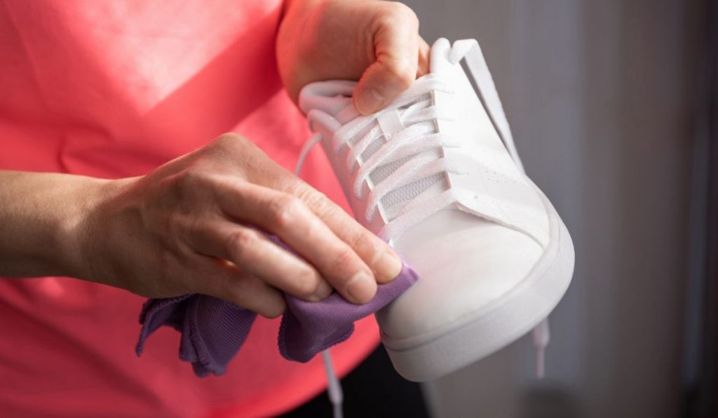girl cleaning white sneakers