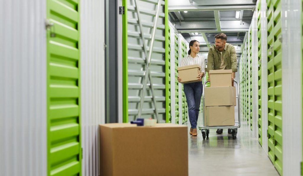 couples moving boxes in the storage facility