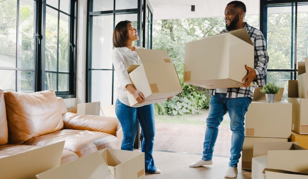 mom and dad carrying boxes