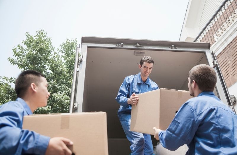 movers bringing boxes to the truck for moving