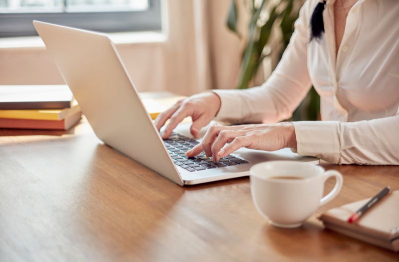 woman working from home on the dining table