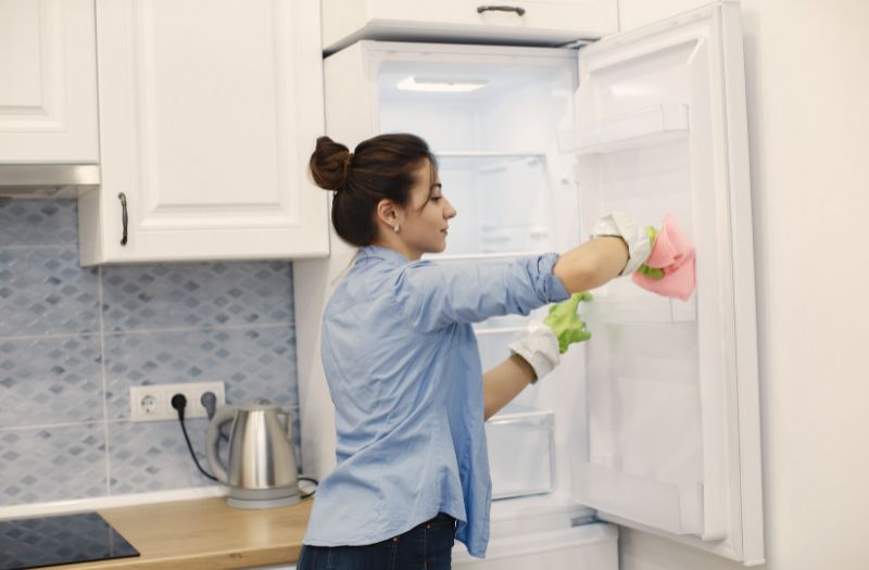 woman cleaning her fridge