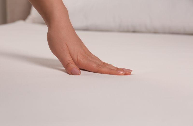 woman touching a nice bedsheet