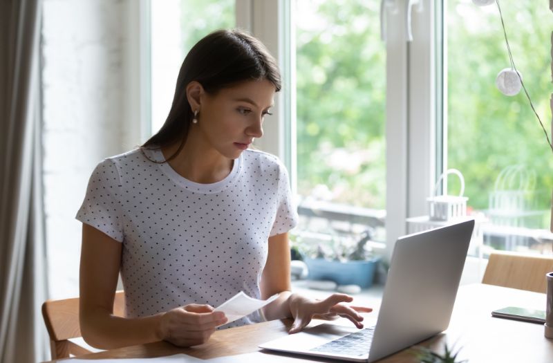 woman on her computer managing her expenses