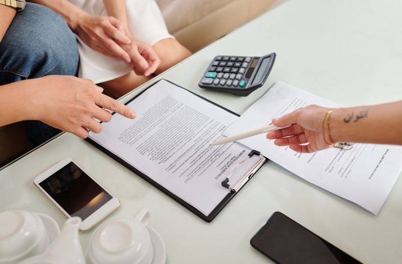 couple reviewing the lease agreement and signing it