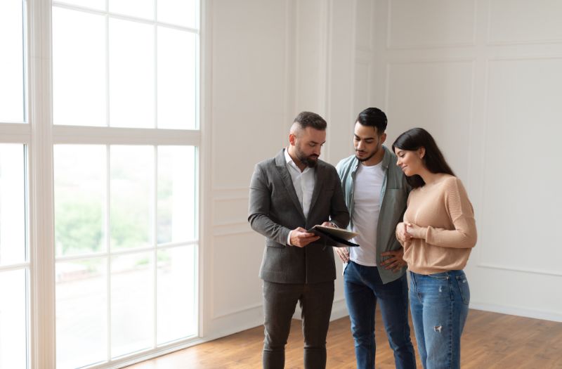 couple talking to the landlord about the house for rent