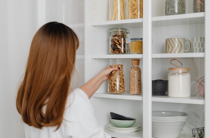 woman getting food in the pantry