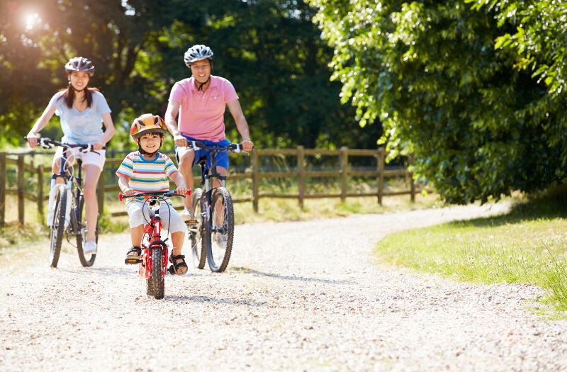 family biking together at the park