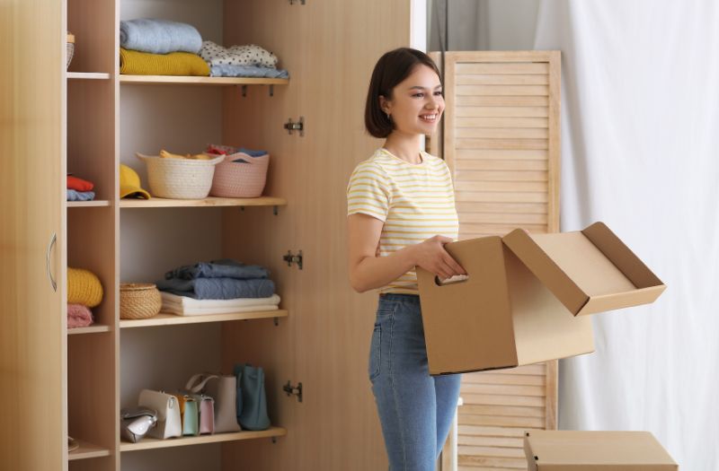 woman holding a box ready to declutter