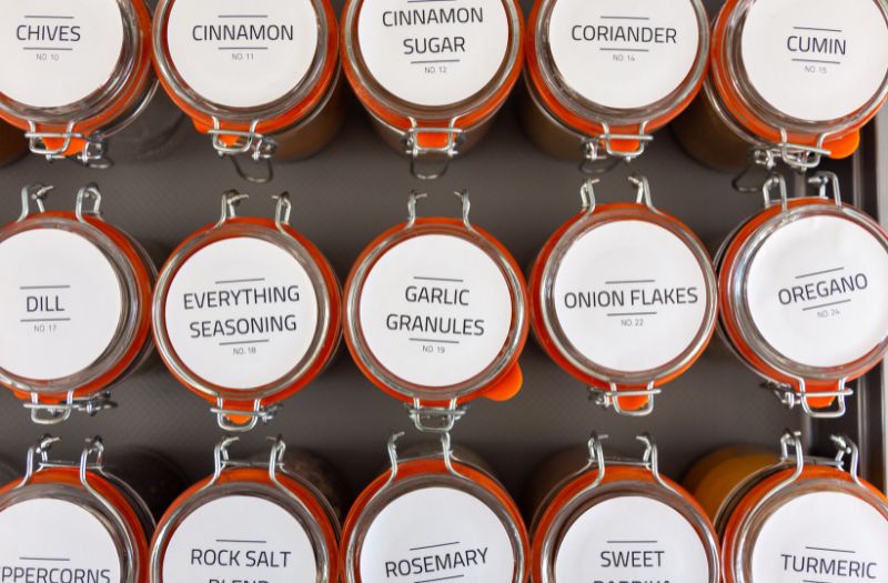 different seasoning in a little mason jars with uniform labels