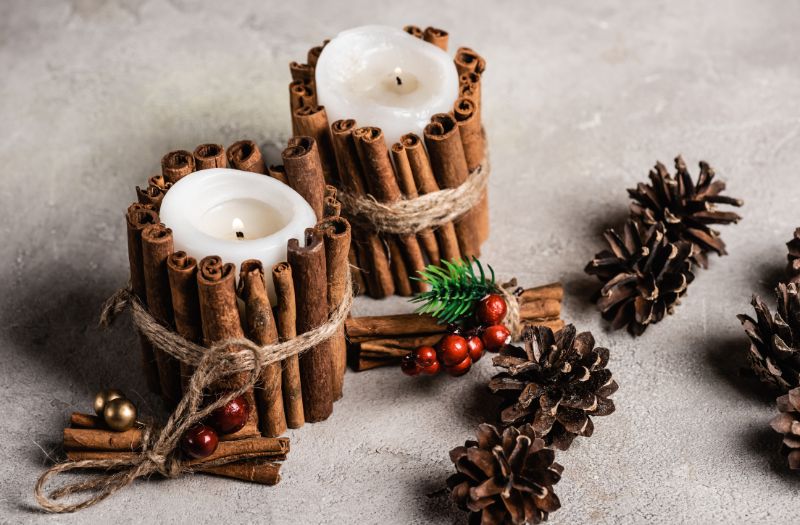 christmas scented candles with some dried pine cones