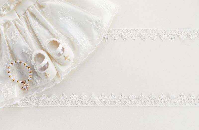 baby christening clothes and a rosary